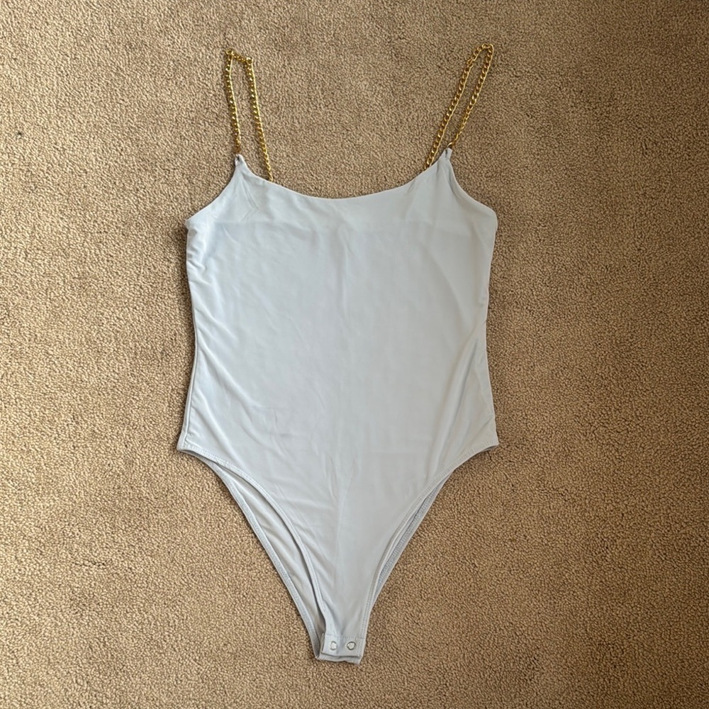 White and Gold Bodysuit with High-Cut Design